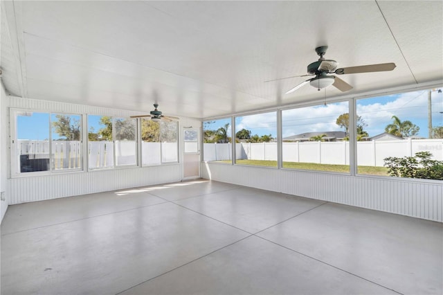 unfurnished sunroom with a ceiling fan