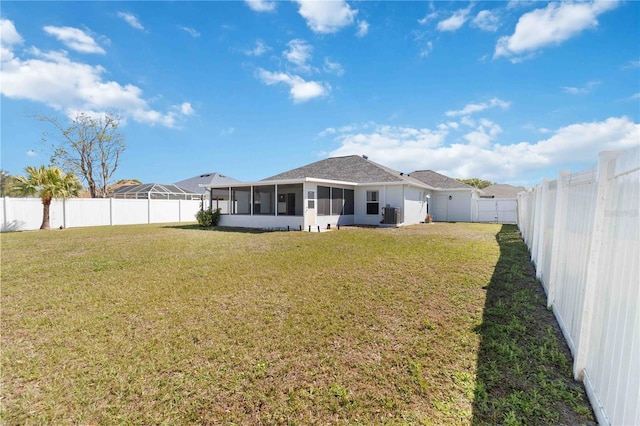 rear view of property with a sunroom and central air condition unit