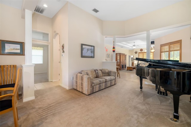 sitting room featuring a ceiling fan, carpet, plenty of natural light, and baseboards