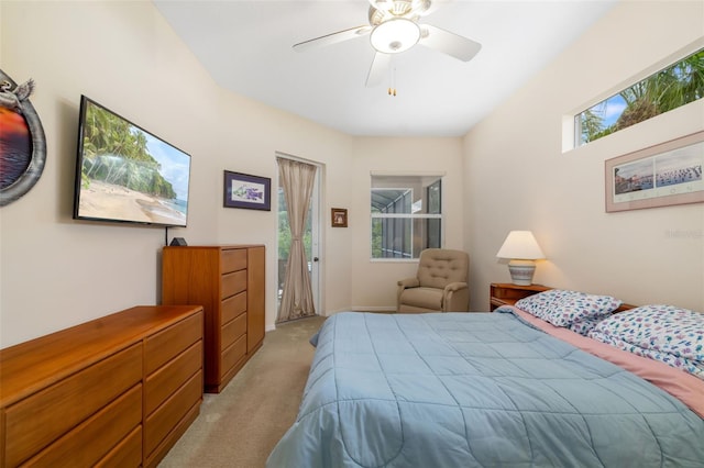 bedroom featuring light colored carpet and a ceiling fan