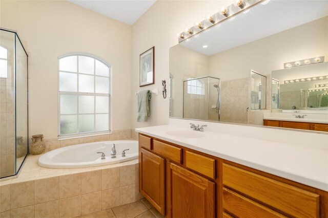 bathroom featuring a shower stall, a bath, tile patterned floors, and vanity