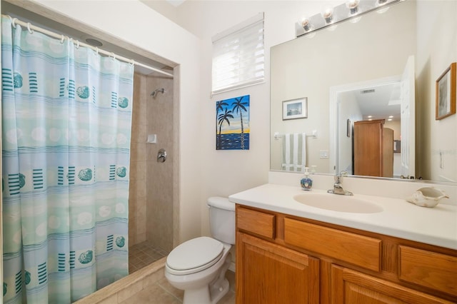 bathroom featuring tiled shower, toilet, vanity, and tile patterned floors