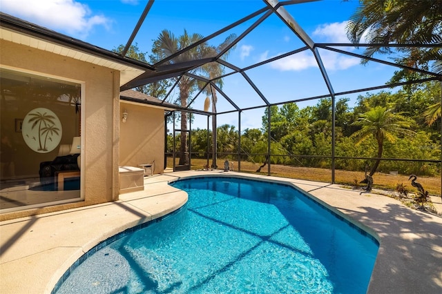outdoor pool with a patio area and glass enclosure