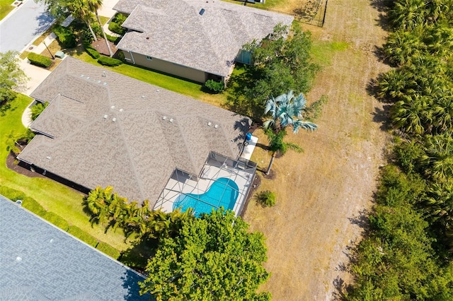 aerial view of property and surrounding area featuring a pool area