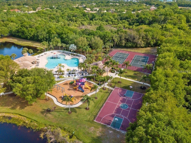 bird's eye view of a heavily wooded area and a pool area