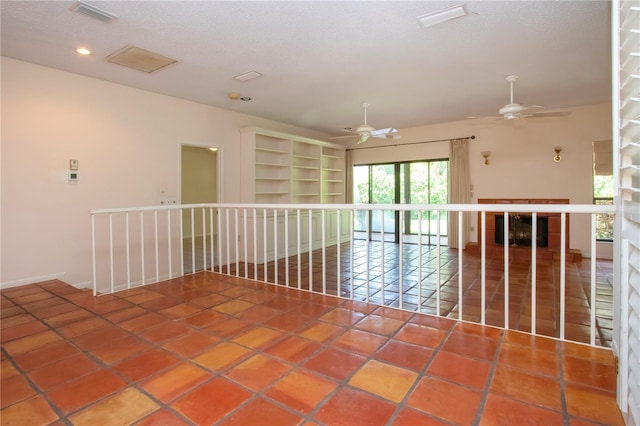 4812 Kestral Park Cir Unit 20, Sarasota, FL 34231 - spare room featuring ceiling fan, a textured ceiling, visible vents, and built in shelves