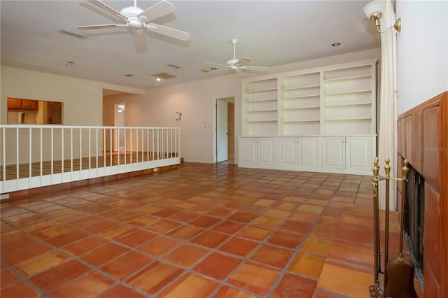 4812 Kestral Park Cir Unit 20, Sarasota, FL 34231 - unfurnished room with visible vents, a fireplace, ceiling fan, and built in shelves