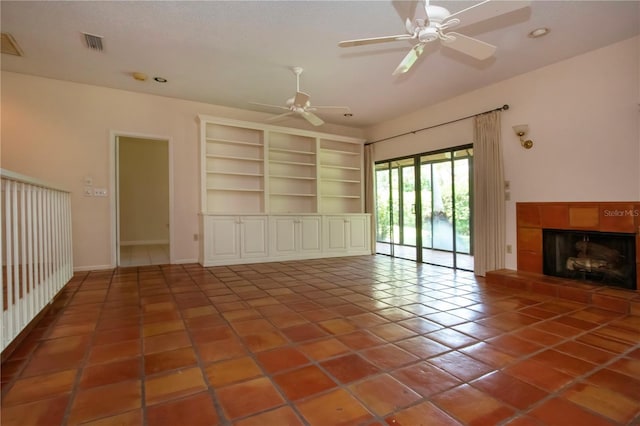4812 Kestral Park Cir Unit 20, Sarasota, FL 34231 - unfurnished living room with baseboards, ceiling fan, visible vents, tile patterned flooring, and a fireplace
