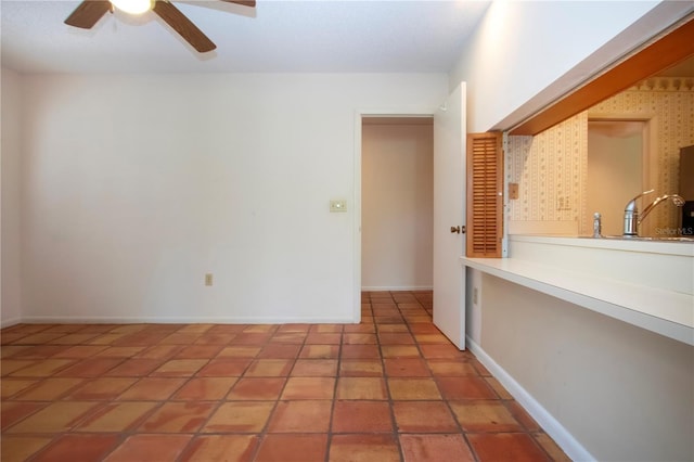 4812 Kestral Park Cir Unit 20, Sarasota, FL 34231 - spare room featuring a sink, ceiling fan, and baseboards