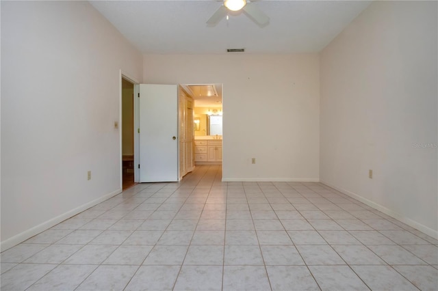 4812 Kestral Park Cir Unit 20, Sarasota, FL 34231 - unfurnished room featuring light tile patterned floors, a ceiling fan, attic access, visible vents, and baseboards