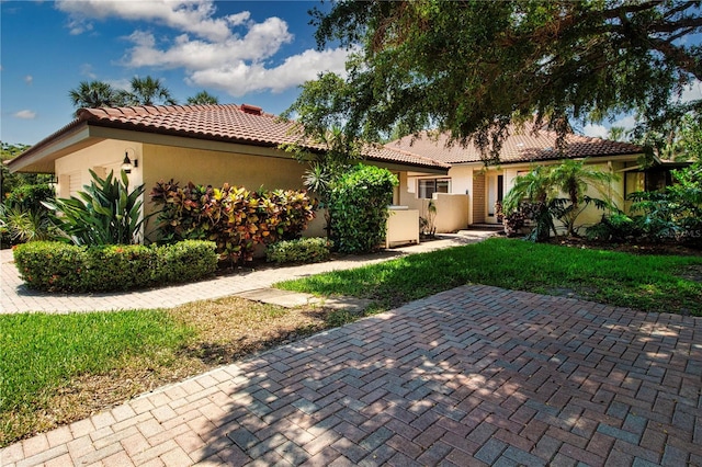 4812 Kestral Park Cir Unit 20, Sarasota, FL 34231 - view of front of property featuring stucco siding and a tiled roof