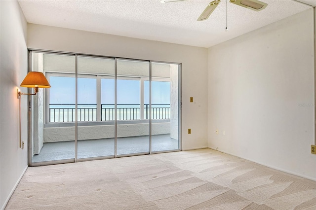 20 Whispering Sands Dr Unit 1201, Sarasota, FL 34242 - spare room with carpet flooring, a ceiling fan, healthy amount of natural light, and a textured ceiling