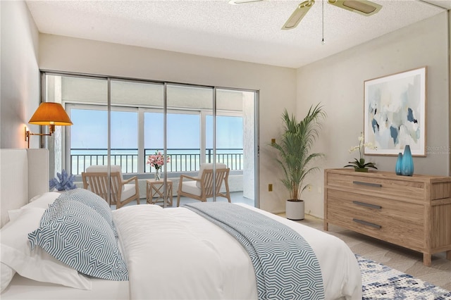 20 Whispering Sands Dr Unit 1201, Sarasota, FL 34242 - bedroom featuring access to exterior, multiple windows, a textured ceiling, light carpet, and a water view