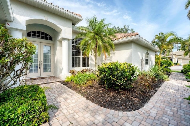 1311 Tuscany Blvd, Venice, FL 34292 - property entrance with french doors and stucco siding