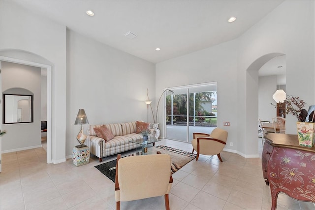1311 Tuscany Blvd, Venice, FL 34292 - living area featuring arched walkways, light tile patterned floors, recessed lighting, and baseboards