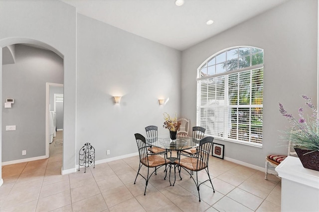 1311 Tuscany Blvd, Venice, FL 34292 - dining space with arched walkways, light tile patterned floors, baseboards, and recessed lighting