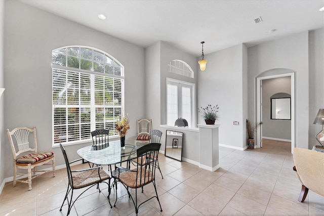 1311 Tuscany Blvd, Venice, FL 34292 - dining area with plenty of natural light, light tile patterned flooring, baseboards, recessed lighting, and arched walkways