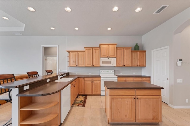1311 Tuscany Blvd, Venice, FL 34292 - kitchen with white appliances, open shelves, dark countertops, a sink, and a kitchen island