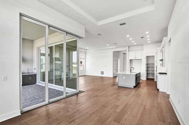 17927 Palmiste Dr, Bradenton, FL 34202 - unfurnished living room featuring dark wood-type flooring, a sink, recessed lighting, and baseboards
