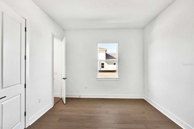 17927 Palmiste Dr, Bradenton, FL 34202 - unfurnished bedroom with wood finished floors and baseboards