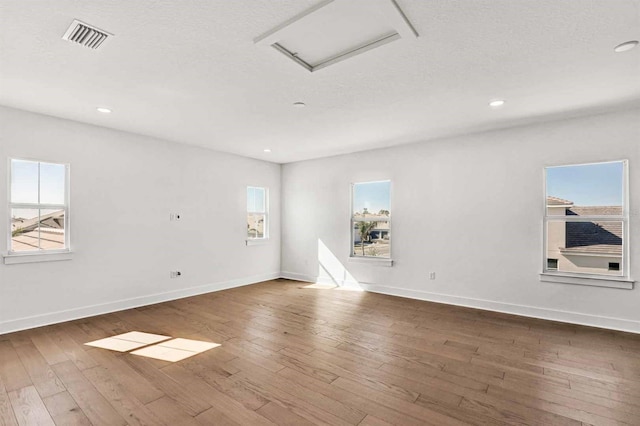 17927 Palmiste Dr, Bradenton, FL 34202 - unfurnished room featuring attic access, hardwood / wood-style flooring, baseboards, and recessed lighting