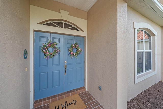 property entrance featuring stucco siding