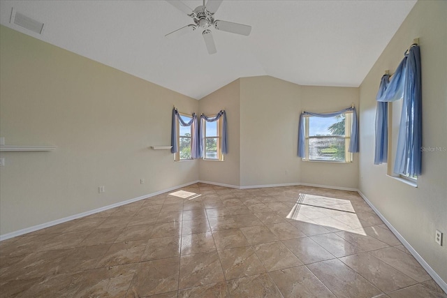 empty room with lofted ceiling, ceiling fan, baseboards, and visible vents