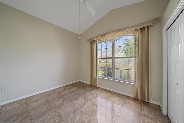 unfurnished room with ceiling fan, lofted ceiling, and baseboards