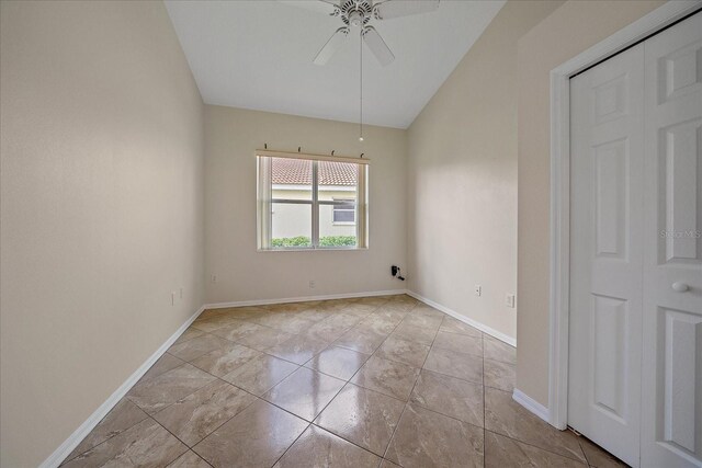 unfurnished room featuring a ceiling fan, baseboards, and vaulted ceiling