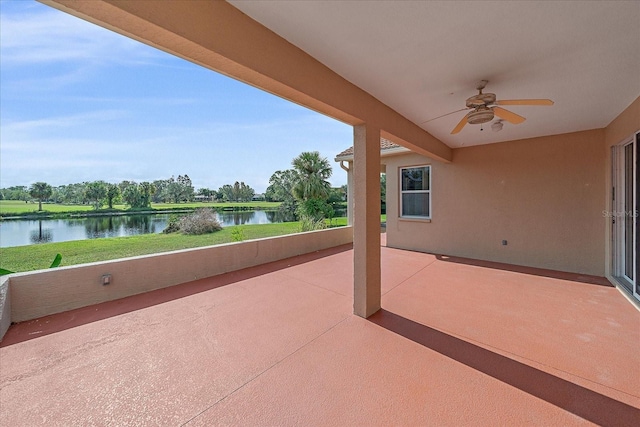 view of patio with ceiling fan and a water view