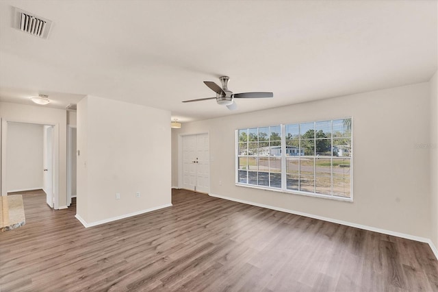 4907 4th Avenue Cir NW, Bradenton, FL 34209 - empty room featuring ceiling fan, baseboards, visible vents, and wood finished floors