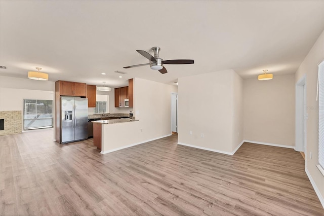 4907 4th Avenue Cir NW, Bradenton, FL 34209 - kitchen featuring brown cabinetry, stainless steel appliances, open floor plan, and light wood finished floors
