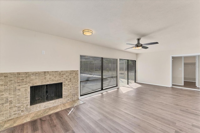 4907 4th Avenue Cir NW, Bradenton, FL 34209 - unfurnished living room featuring a tile fireplace, wood finished floors, baseboards, and ceiling fan