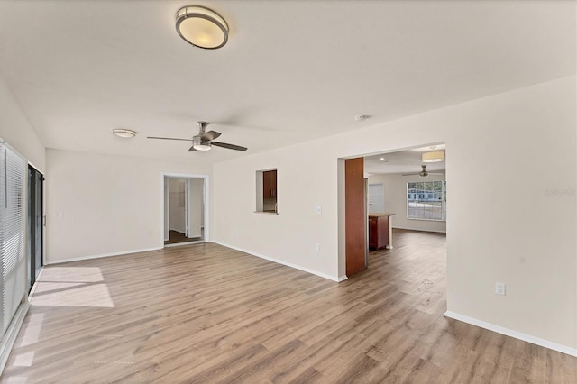 4907 4th Avenue Cir NW, Bradenton, FL 34209 - unfurnished living room with light wood-type flooring, baseboards, and a ceiling fan