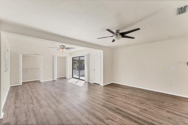 4907 4th Avenue Cir NW, Bradenton, FL 34209 - unfurnished living room with a ceiling fan, baseboards, visible vents, and wood finished floors