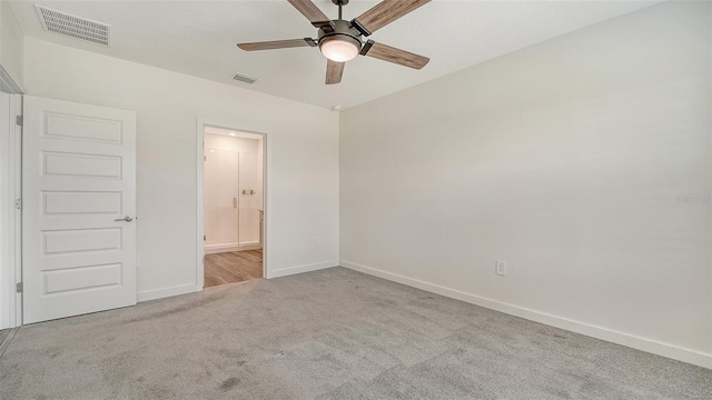 unfurnished bedroom with carpet flooring, baseboards, and visible vents