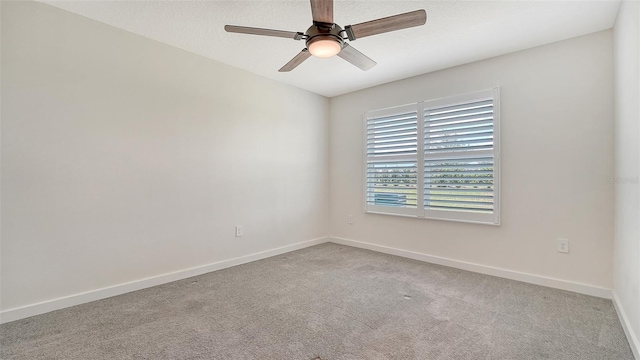 empty room featuring baseboards, ceiling fan, and carpet floors