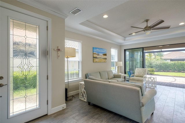5301 Bartolomeo St, Sarasota, FL 34238 - living room featuring wood finished floors, ornamental molding, plenty of natural light, ceiling fan, and baseboards