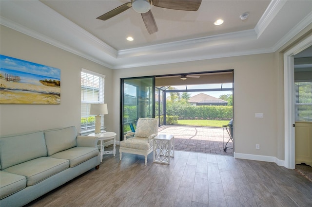 5301 Bartolomeo St, Sarasota, FL 34238 - living area featuring a tray ceiling, a ceiling fan, wood finished floors, crown molding, and baseboards