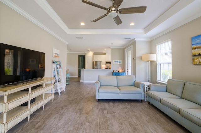 5301 Bartolomeo St, Sarasota, FL 34238 - living area with a raised ceiling, ornamental molding, wood finished floors, ceiling fan, and recessed lighting