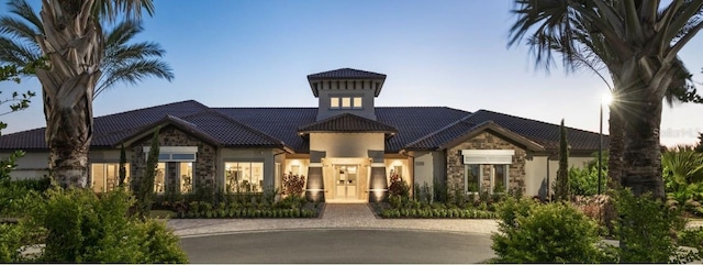 5301 Bartolomeo St, Sarasota, FL 34238 - mediterranean / spanish house featuring stone siding, a tile roof, and stucco siding