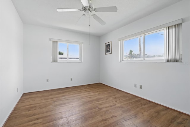 3105 Gulfgate Dr, Sarasota, FL 34231 - spare room with wood finished floors, baseboards, and a ceiling fan