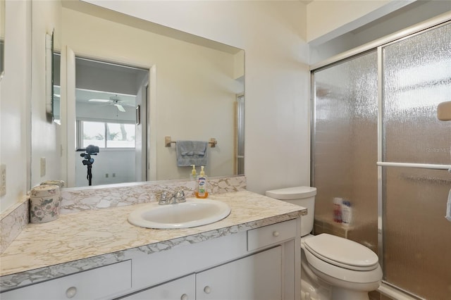 3105 Gulfgate Dr, Sarasota, FL 34231 - bathroom featuring vanity, toilet, a stall shower, and ceiling fan