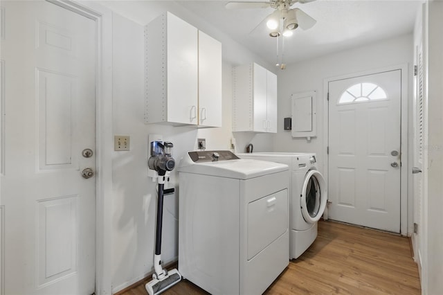 3105 Gulfgate Dr, Sarasota, FL 34231 - laundry room featuring cabinet space, independent washer and dryer, ceiling fan, electric panel, and light wood-type flooring
