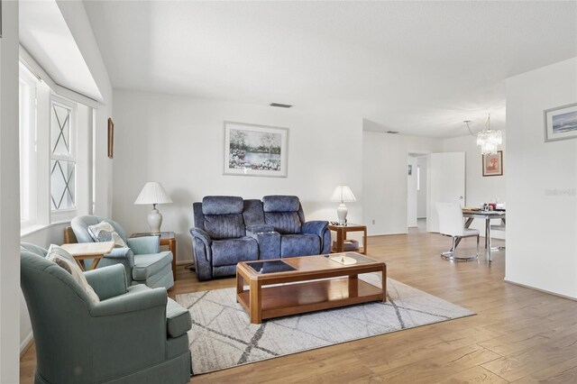 3105 Gulfgate Dr, Sarasota, FL 34231 - living area with a chandelier and wood finished floors