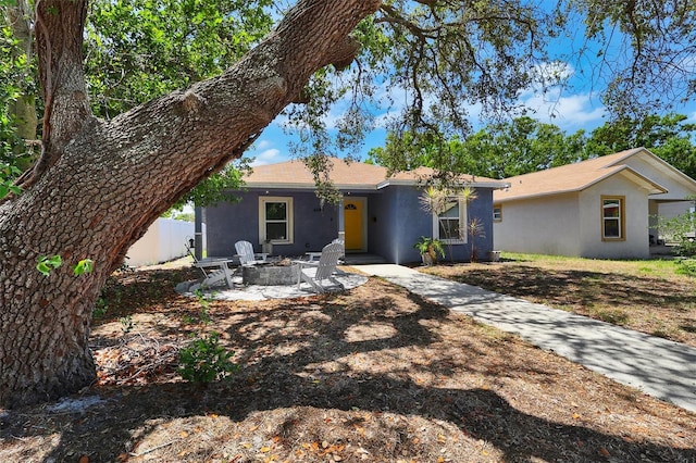 4542 19th Ave S, Saint Petersburg, FL 33711 - single story home featuring an outdoor fire pit, stucco siding, and a patio area