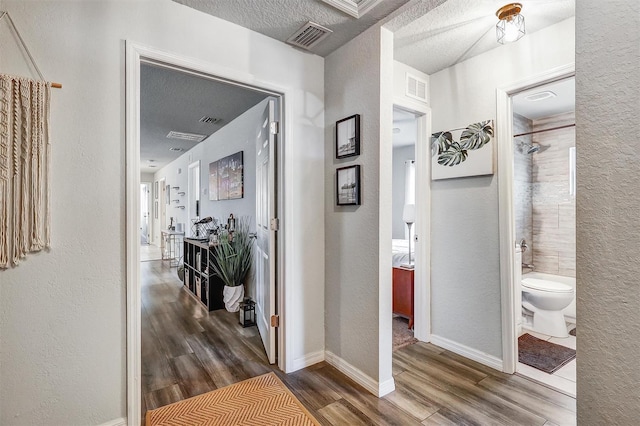 4542 19th Ave S, Saint Petersburg, FL 33711 - hall featuring a textured ceiling, visible vents, and wood finished floors
