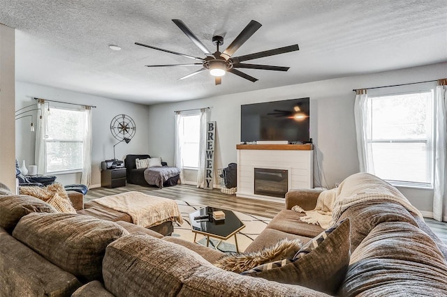 4542 19th Ave S, Saint Petersburg, FL 33711 - living room featuring ceiling fan, a textured ceiling, baseboards, and wood finished floors