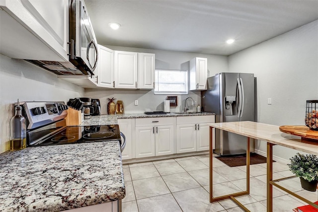 4542 19th Ave S, Saint Petersburg, FL 33711 - kitchen with a sink, stainless steel appliances, light tile patterned flooring, recessed lighting, and white cabinets