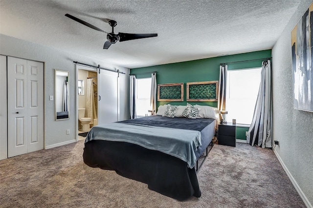 4542 19th Ave S, Saint Petersburg, FL 33711 - bedroom with carpet flooring, a barn door, a textured ceiling, and a textured wall